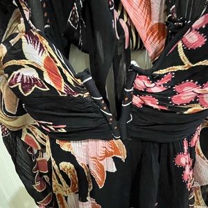 Anthropologie dress.  Black print short dress with cut out back and tie detail.